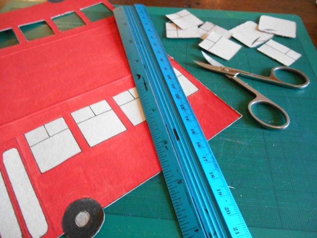 First I re-opened the cardboard model and carefully cut out its windows with a tiny pair of nail scissors